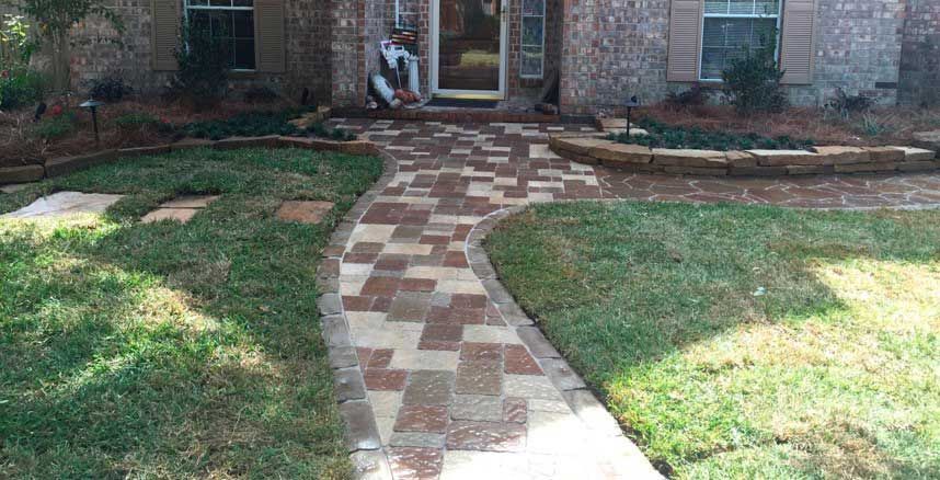 A pathway made of bright bricks in different colors for the house entrance