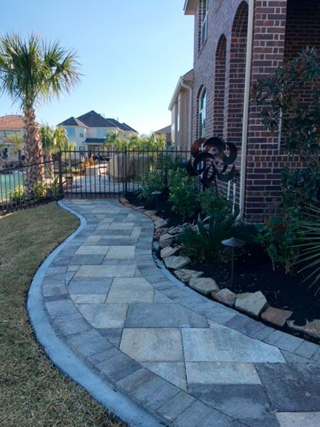 Concrete tile walkway with beautiful landscaping