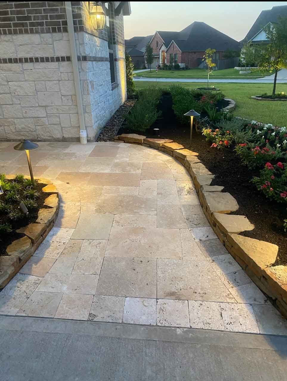 Walking path in limestone with landscaping with flowers and plants