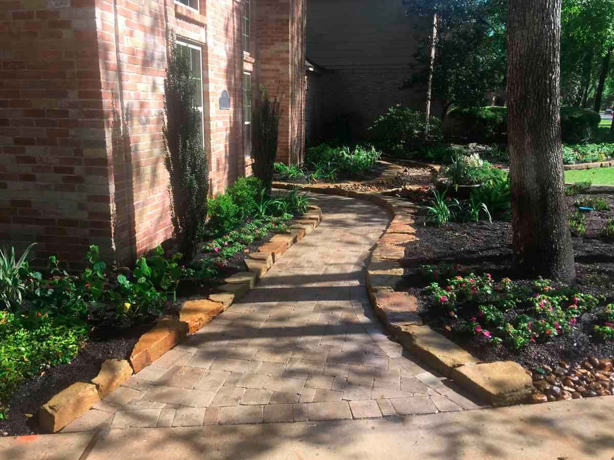 Nice light brick path and stone rolling landscaping beds