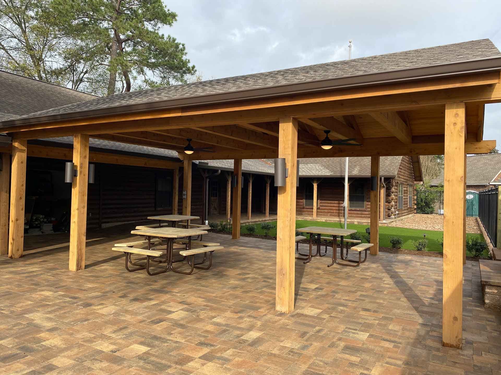 Large limestone patio covered with wood with camping tables