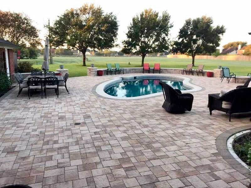 Paves pool deck with pool landscaping and greens