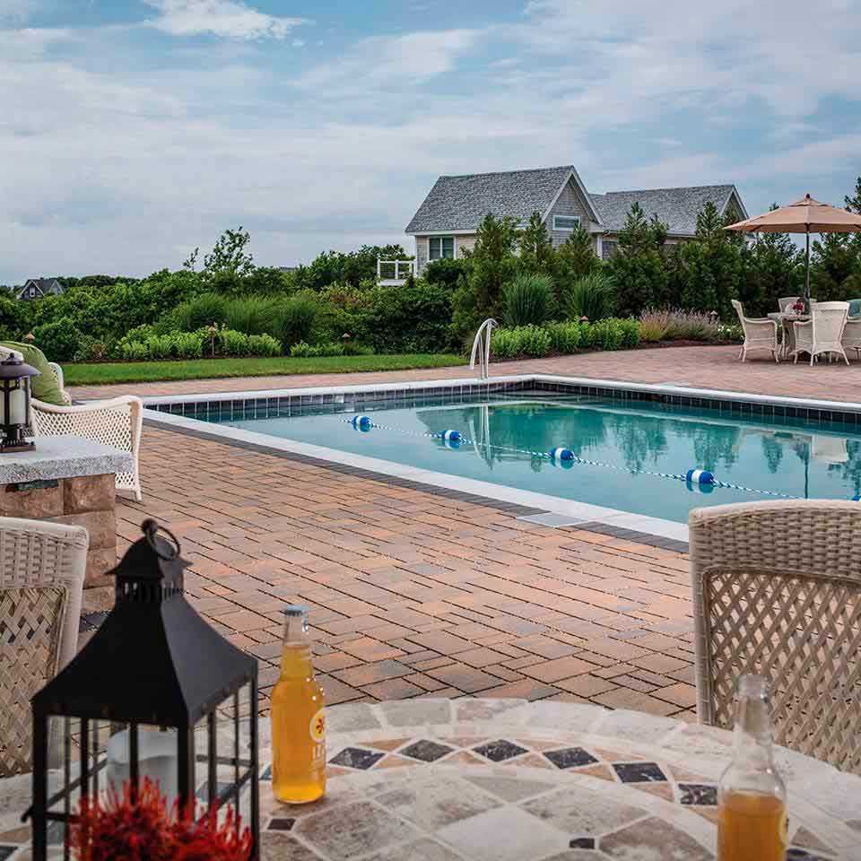 Pool landscaping with pavers deck and fire pit