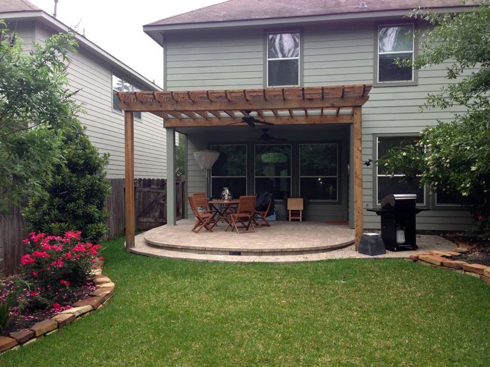 Attached Pergola covering a beautiful circular patio paver