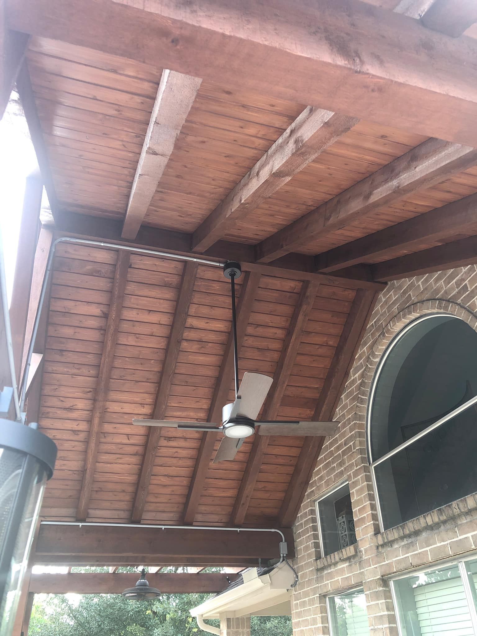 Wooden gable patio cover with blade fan