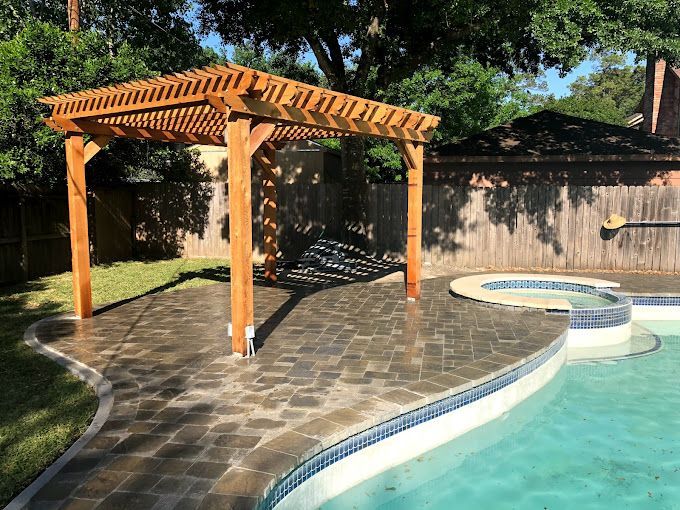 Pool landscaping with wooden pergola