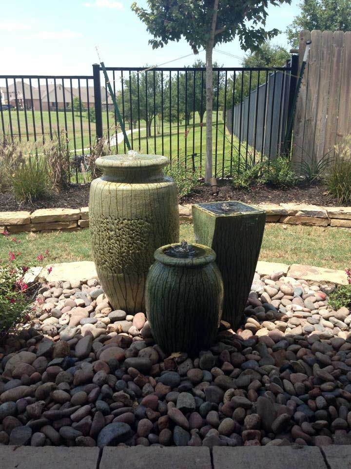 Nice landscaping of river stones with three pondless water fountains