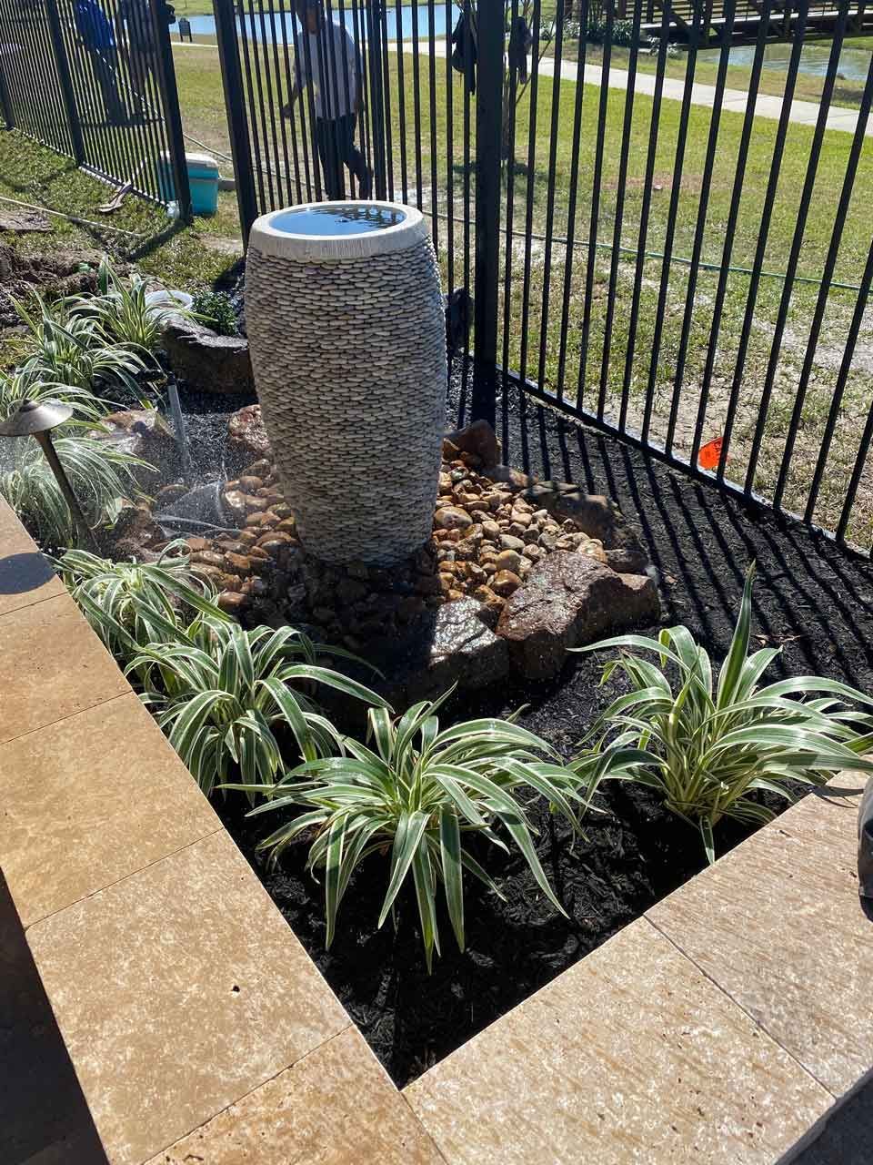 Landscape bed with a pondless fountain