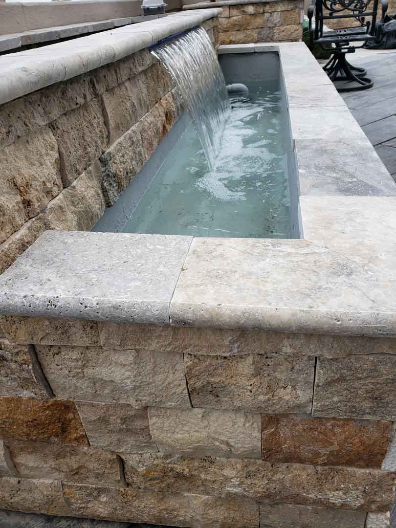 Wall-mounted water fountain with pond