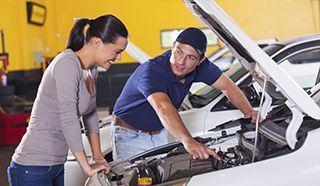 Auto Repair Service Specialist Talking to Local Motorist