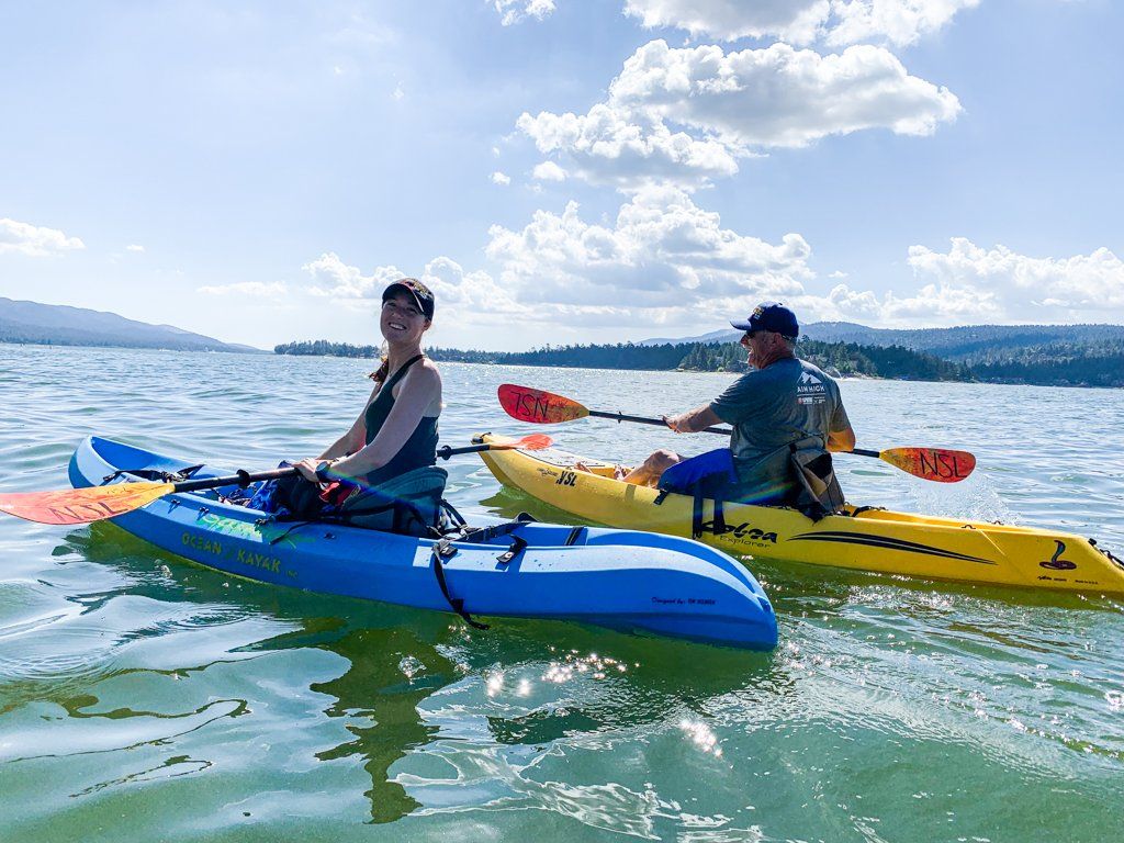 Man and woman in blue and yellow kayaks