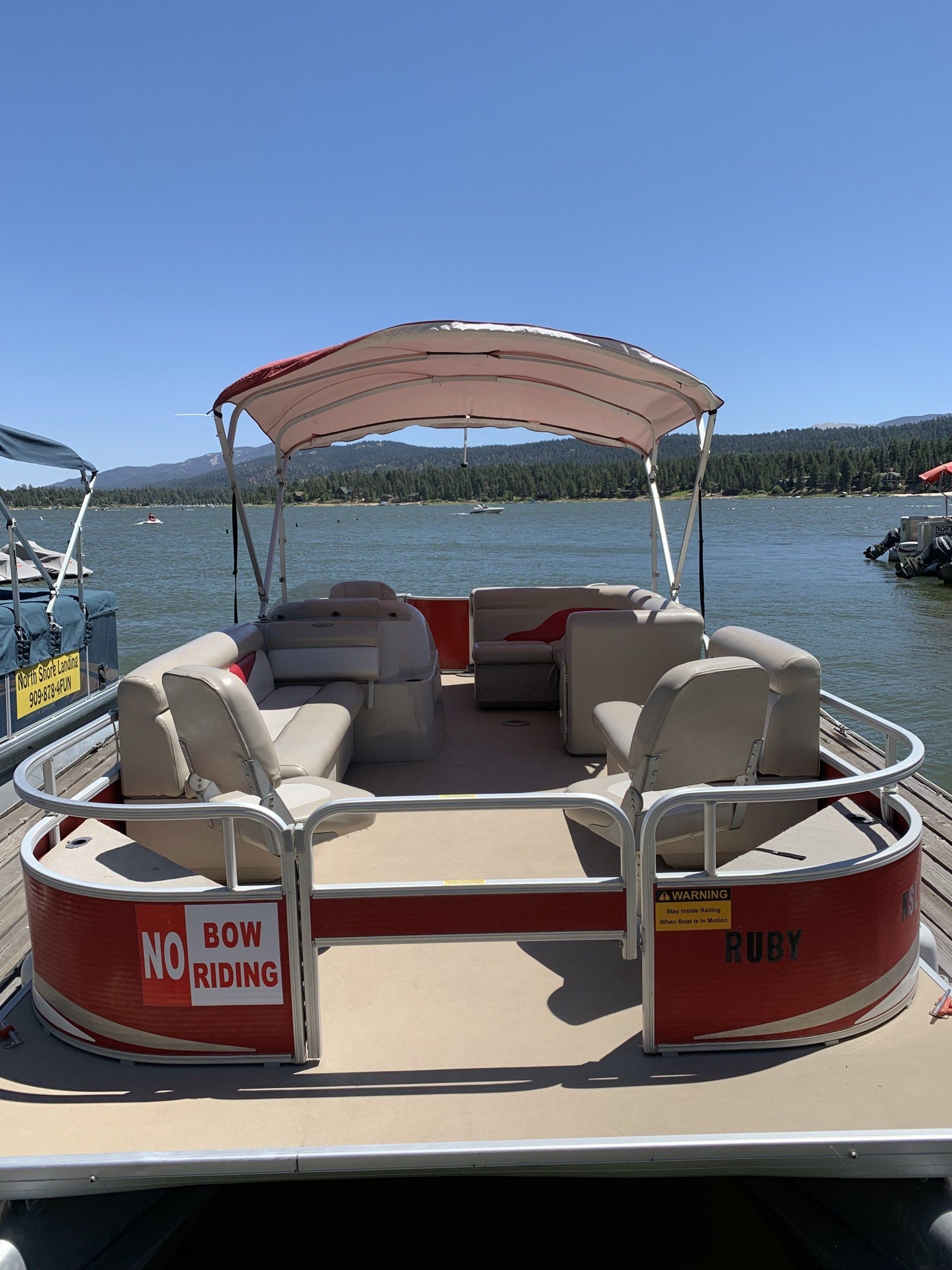 three people in a pontoon on the water