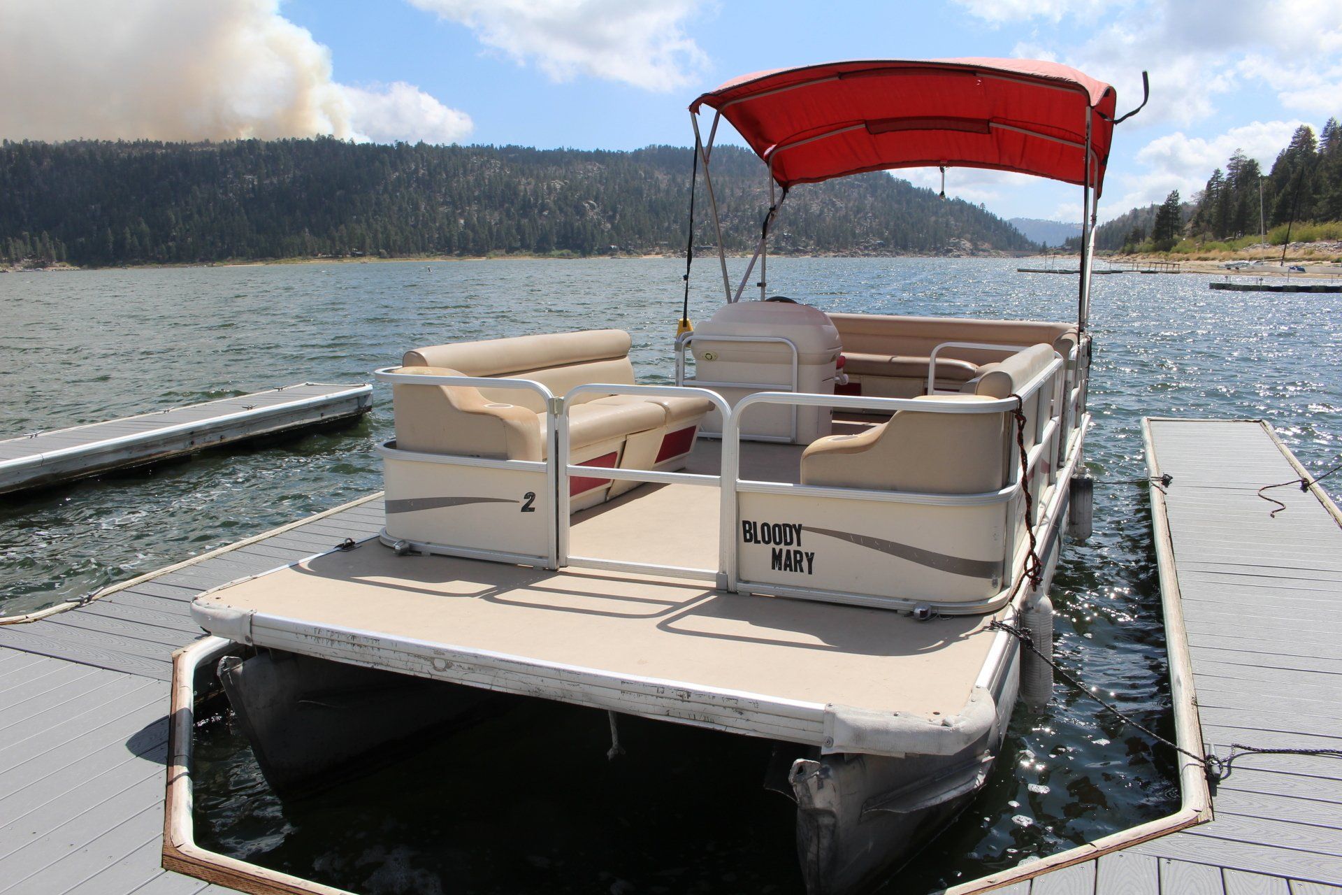 Tan and red pontoon boat in Big Bear Lake