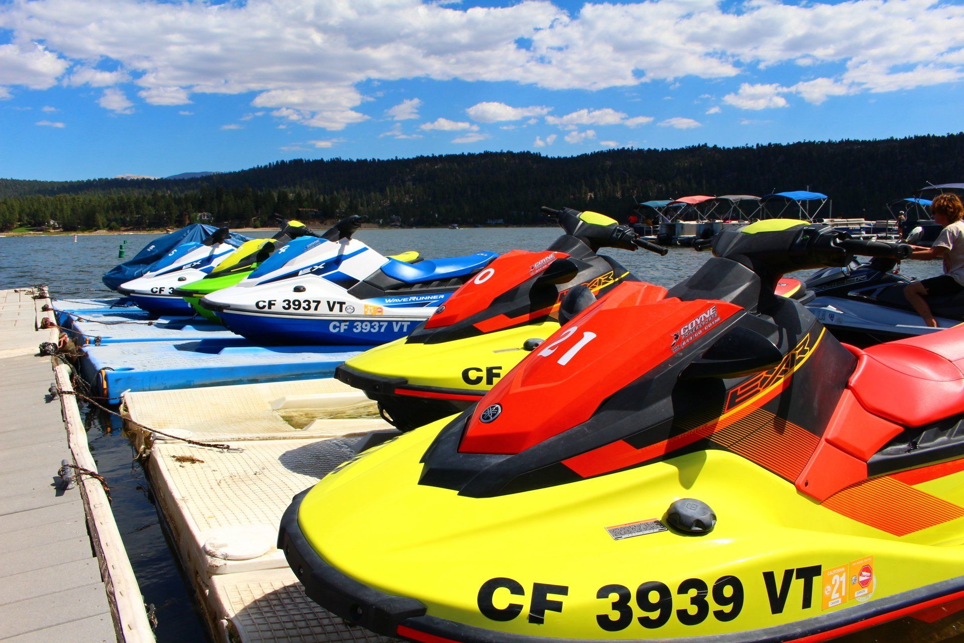 3 colorful jet skis docked at Big Bear Lake CA