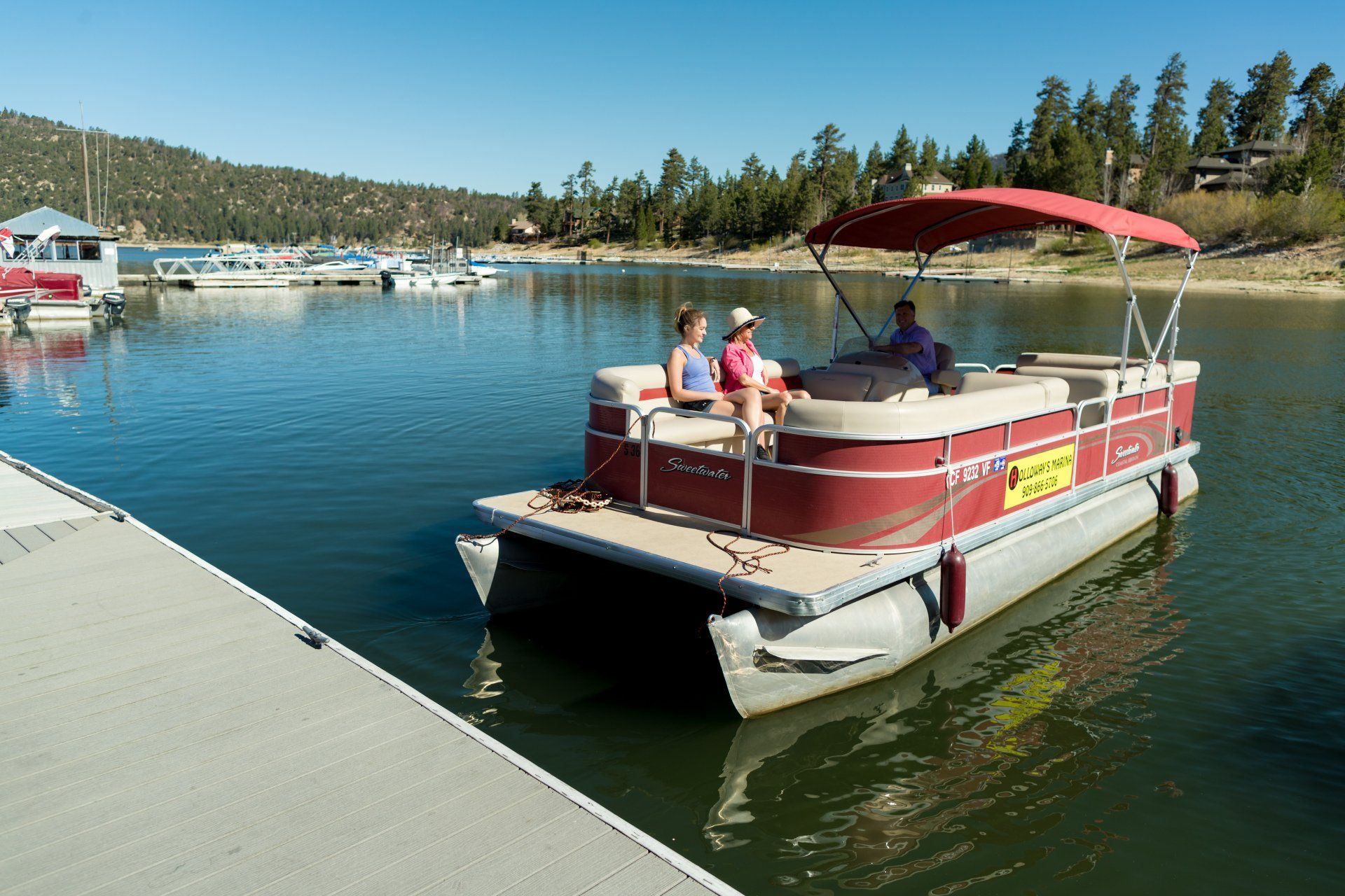 three people in a pontoon on the water