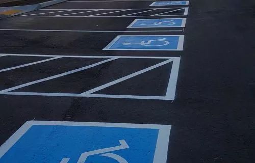 Parking lot with blue and white handicap parking spaces.