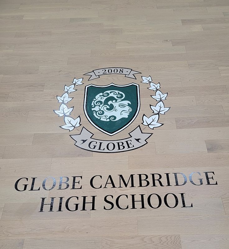 Globe Cambridge High School logo on a wooden floor with surrounding leaves and the year 2008.