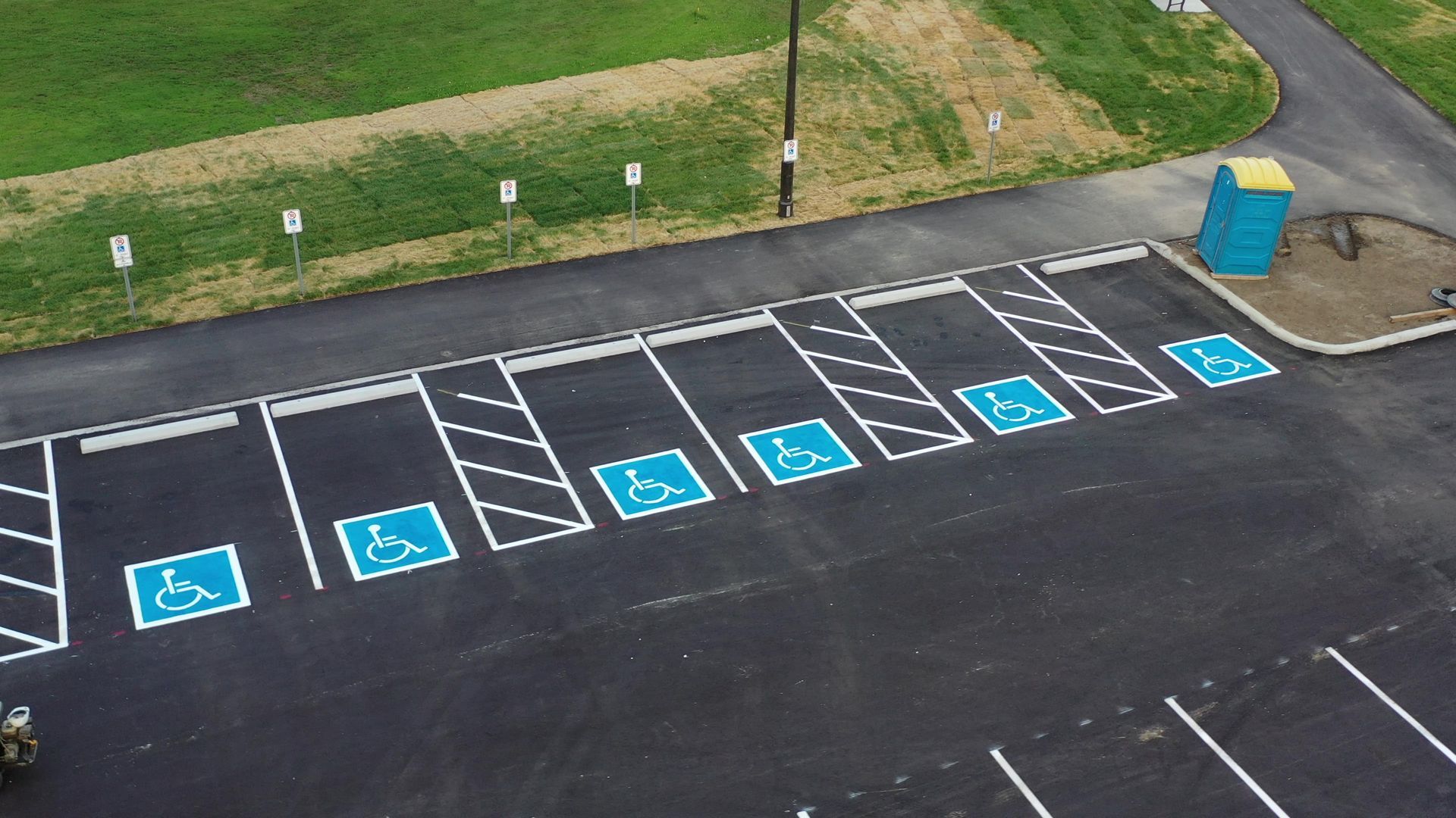 Parking lot with blue handicap symbols marking accessible parking spaces.