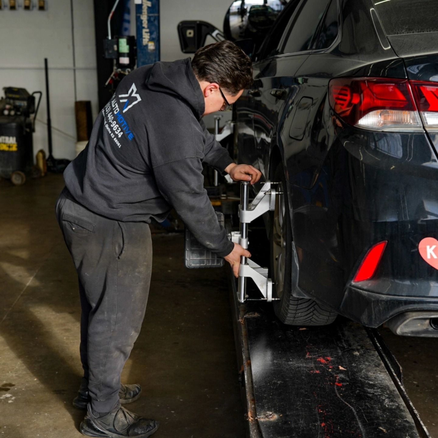 Technician Performing Wheel Alignment On Vehicle | Lenexa, KS