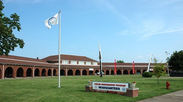 A flag is flying in front of a large building.