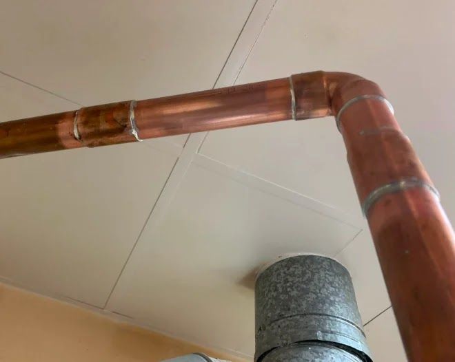A copper pipe is connected to a metal pipe