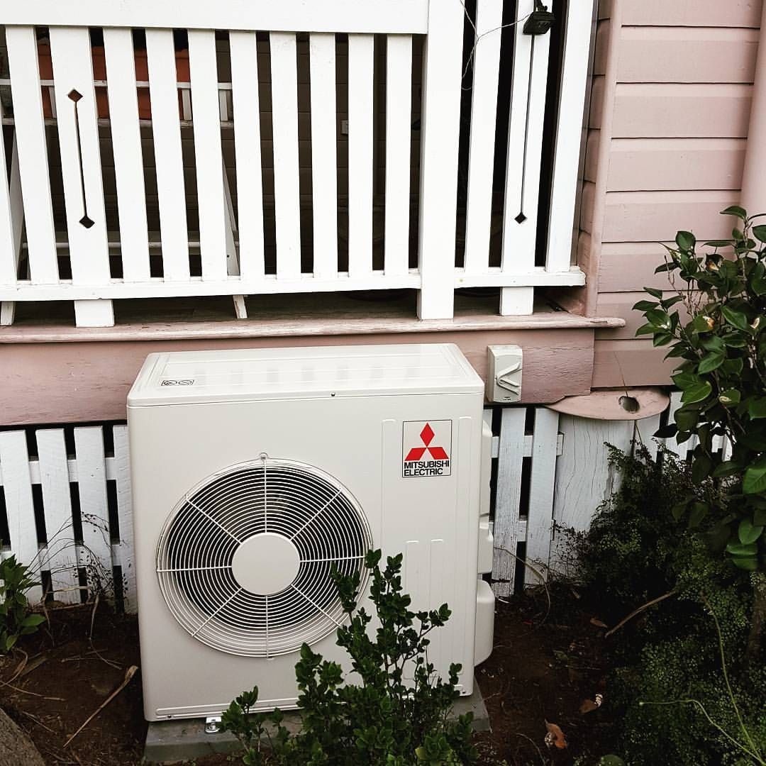 Mitsubishi Air Conditioner Is Sitting Outside Of A House — Stand Fast Electrical Pty Ltd in Inglewood, QLD