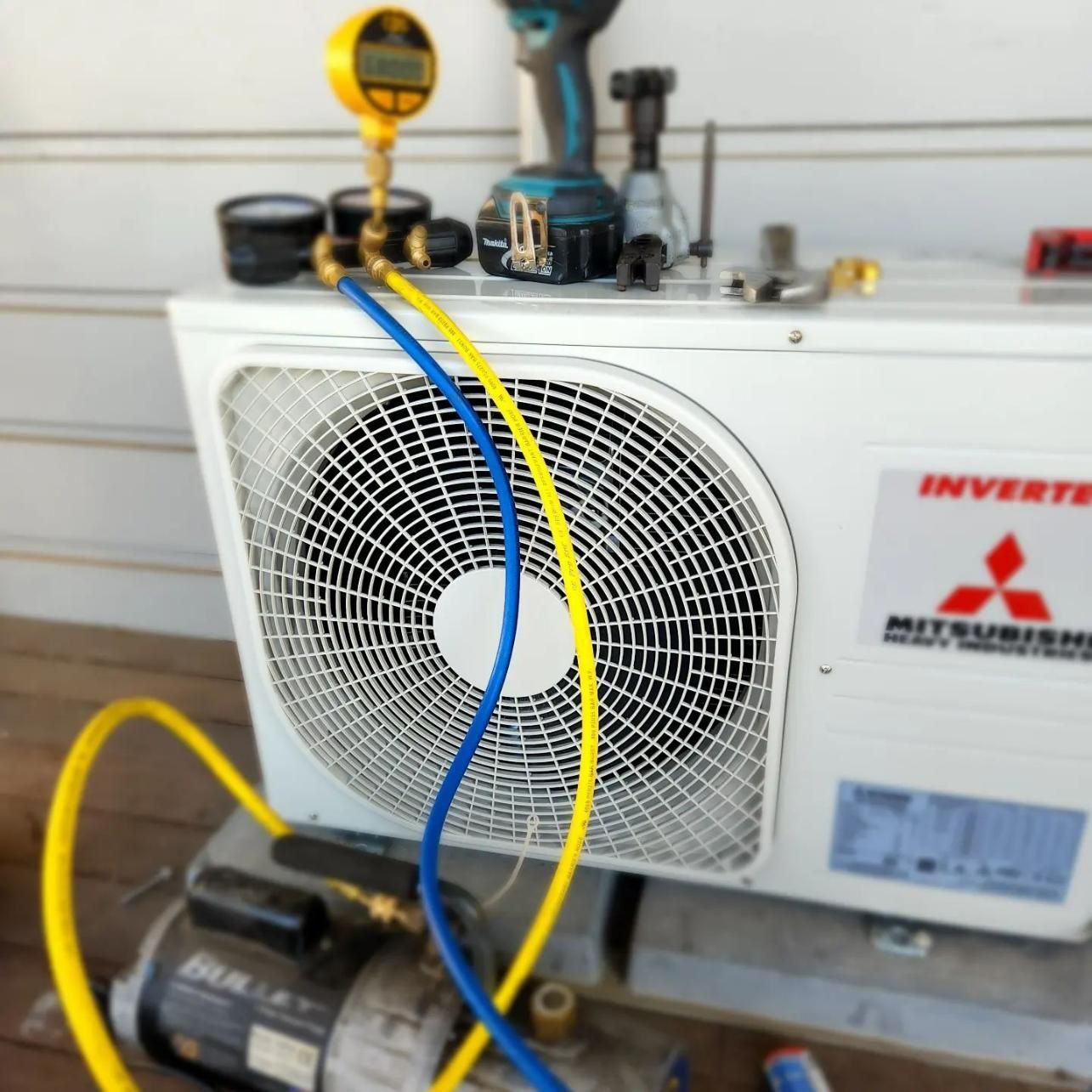 Mitsubishi Air Conditioner Being Serviced By A Technician — Stand Fast Electrical Pty Ltd in Inglewood, QLD