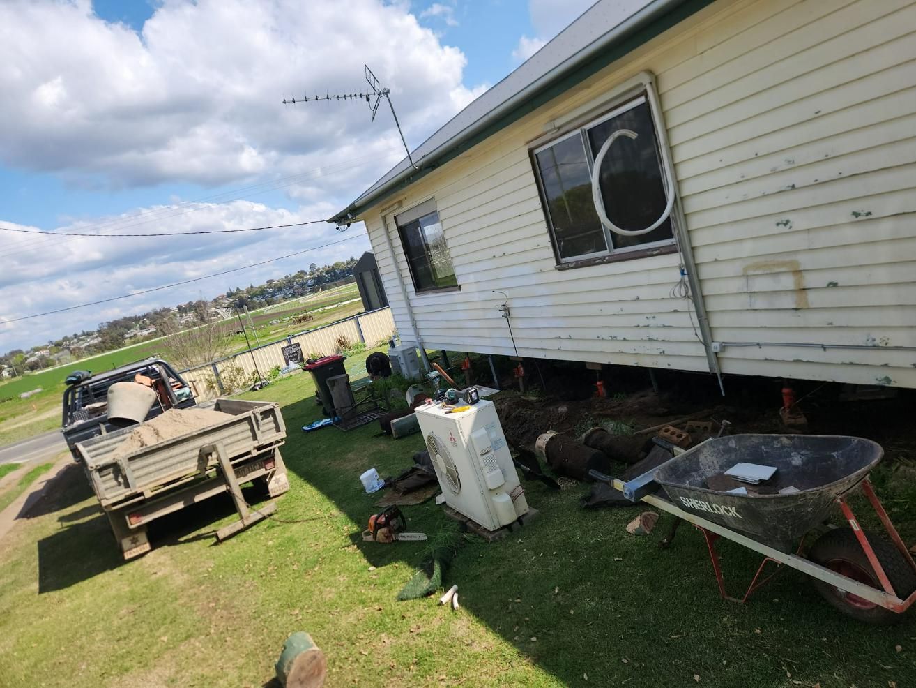 Fixing The Air Conditioner Outside The House — Stand Fast Electrical Pty Ltd in Killarney, QLD