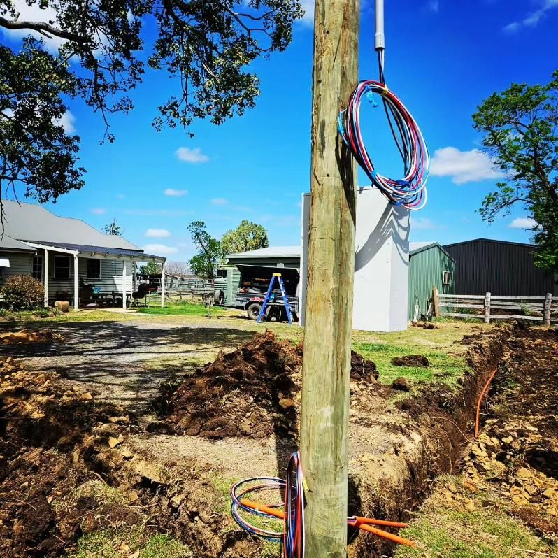 Wooden Pole With Bunch Of Wires Hanging On It — Stand Fast Electrical Pty Ltd in Killarney, QLD