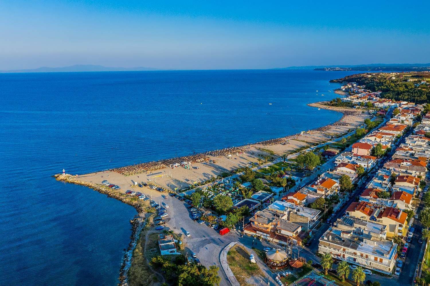 Aerial view of a coastal neighborhood with a sandy beach and blue ocean along the shore