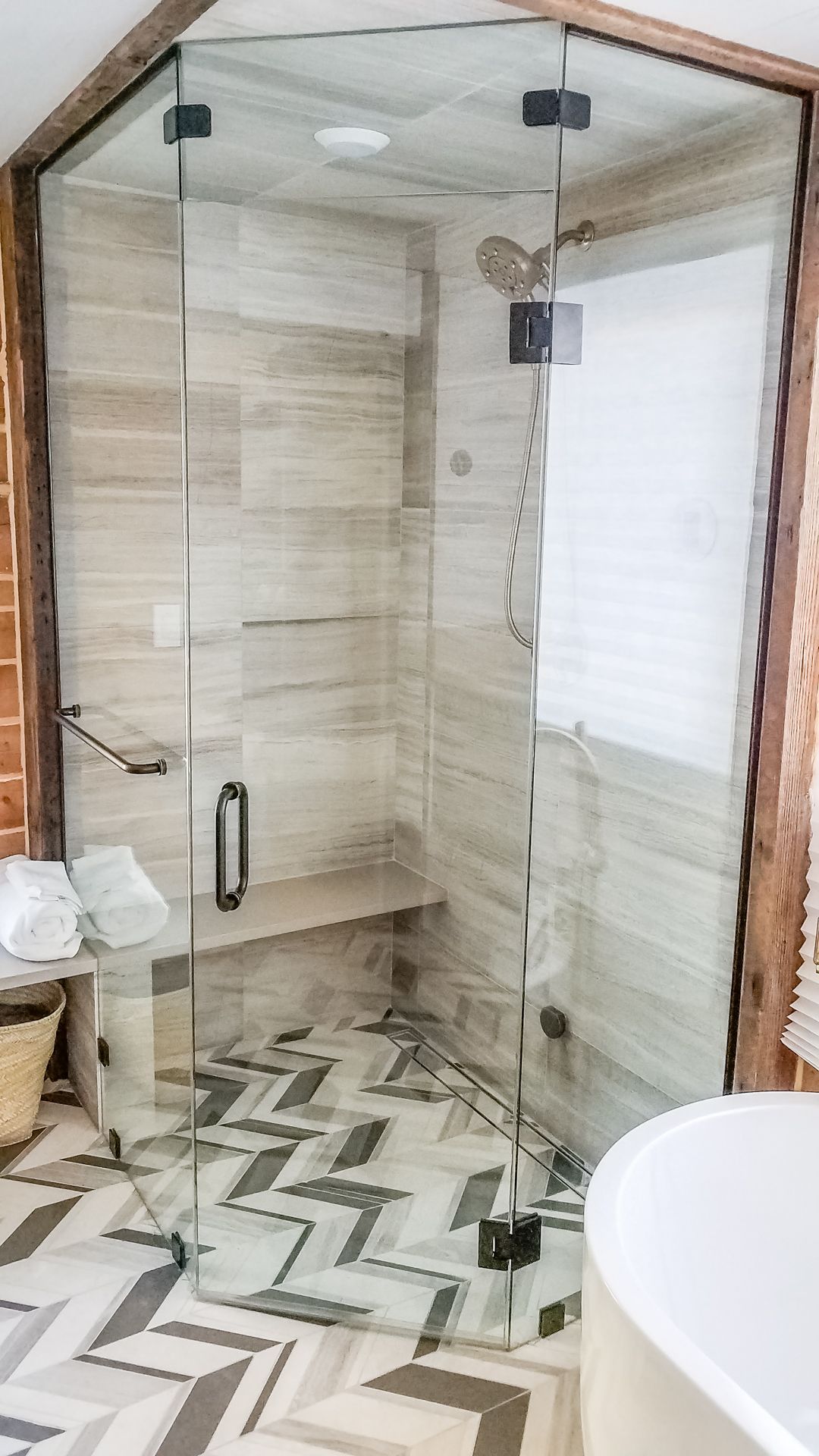 A bathroom with a walk in shower and a bathtub.