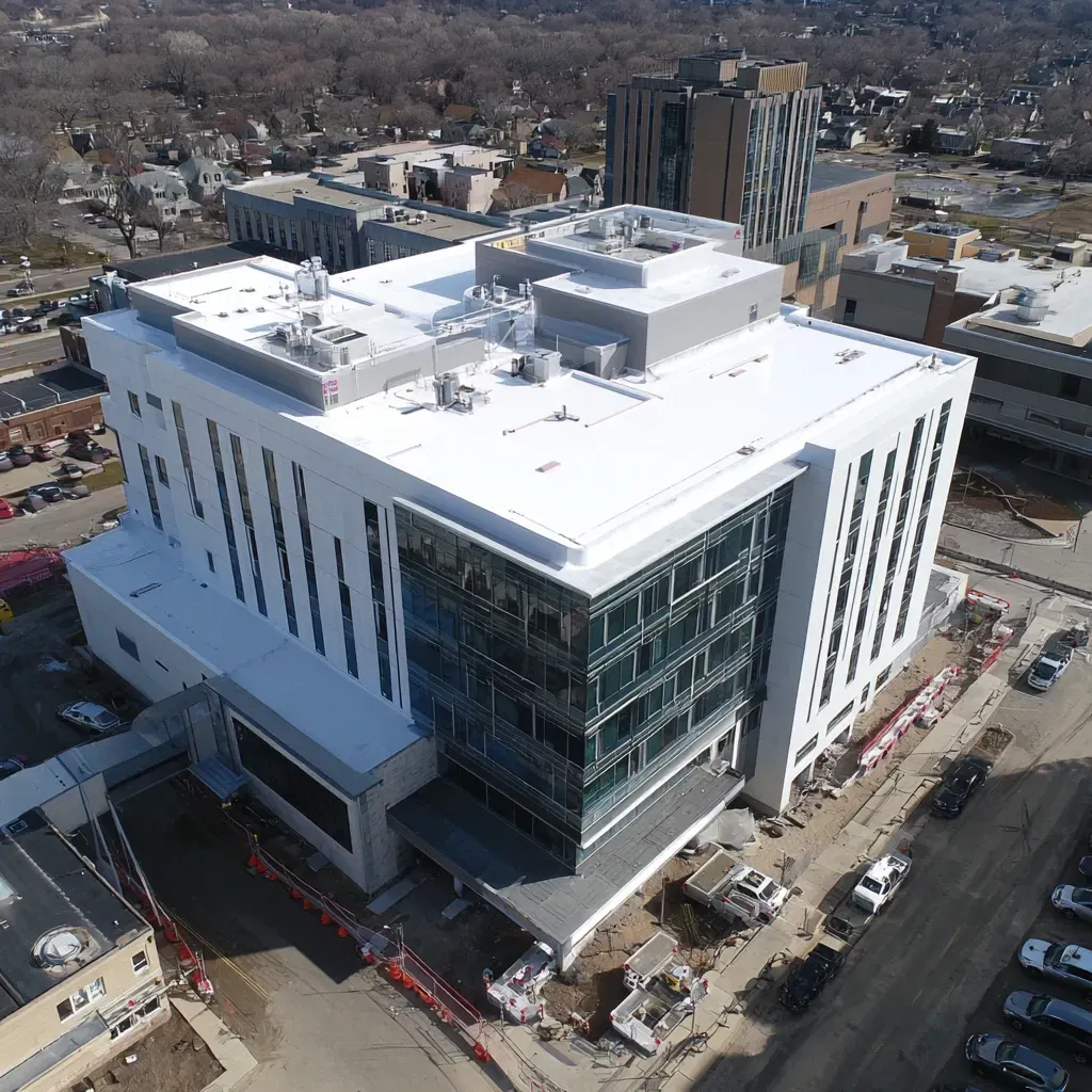 Reflective roof replacement Evanston IL with white membrane tear-off and installation, insulation upgrades, improved drainage slope, and solar heat deflection for warehouse and retail centers.