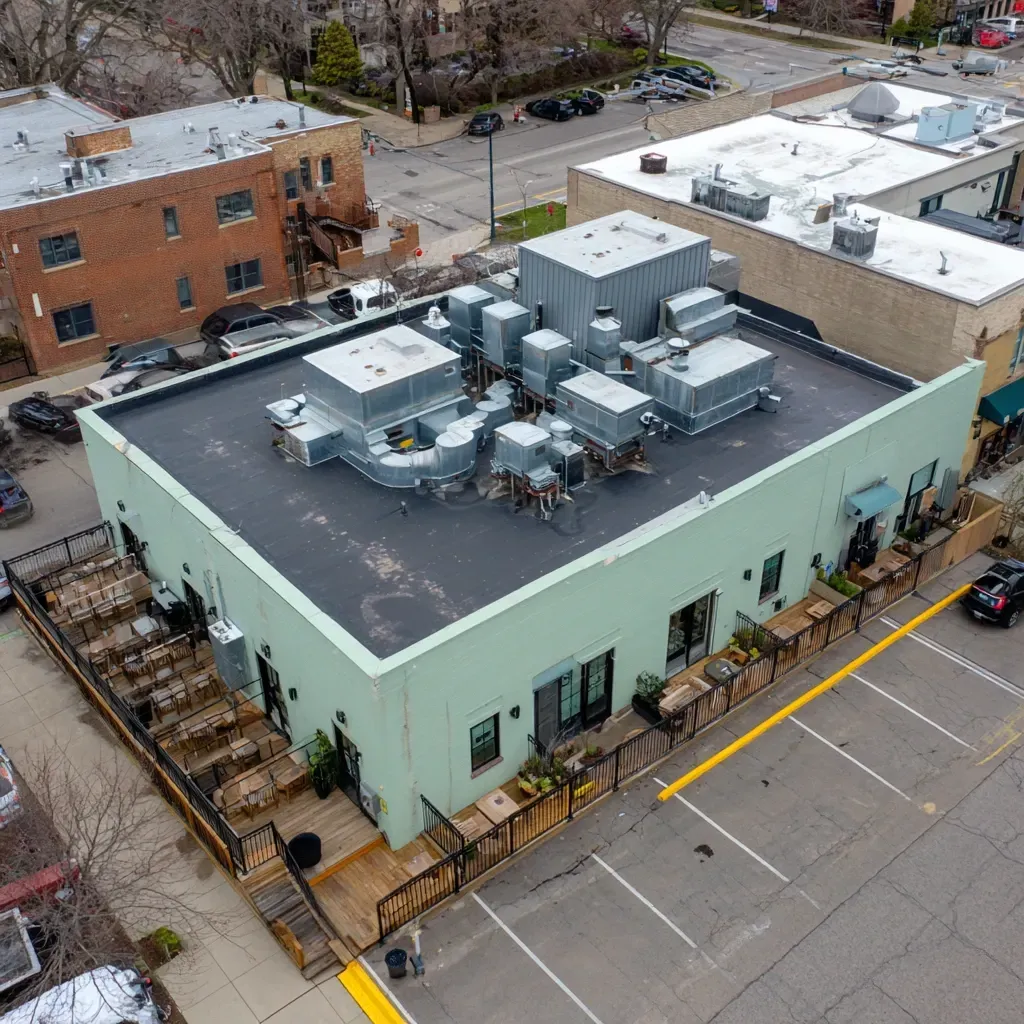 Re-roof and overlay commercial flat roof installation Evanston IL using recover boards, membrane overlay application, perimeter flashing updates, and full building code compliance across Evanston Illinois.