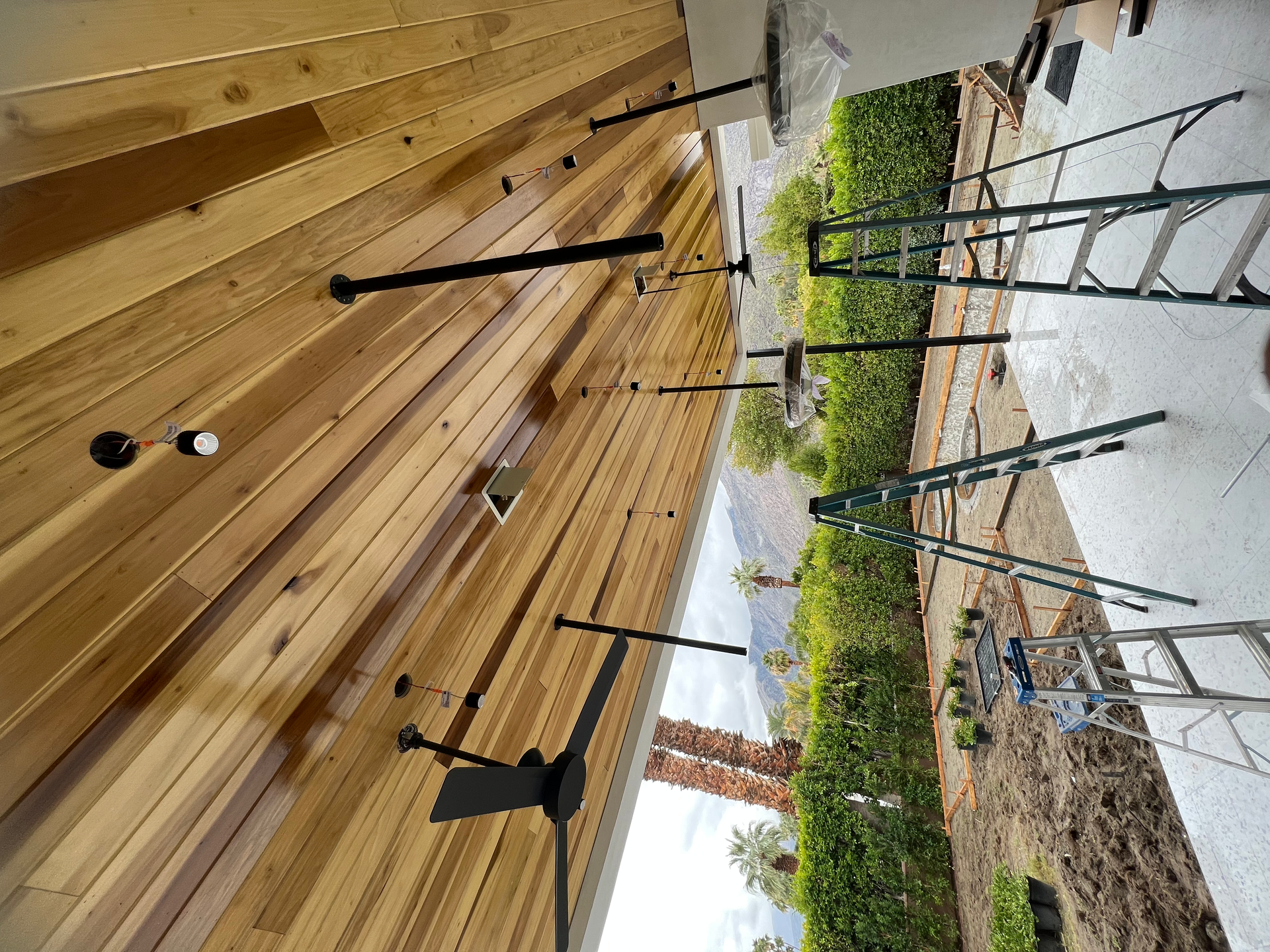 A wooden wall with a ladder in the background