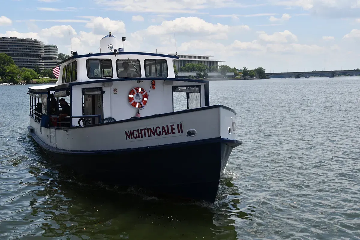 Lincoln Memorial at night, illuminated by lights, with the Lincoln statue visible in the center.