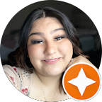 Smiling woman with dark hair, light floral top, and an orange, star-shaped logo.