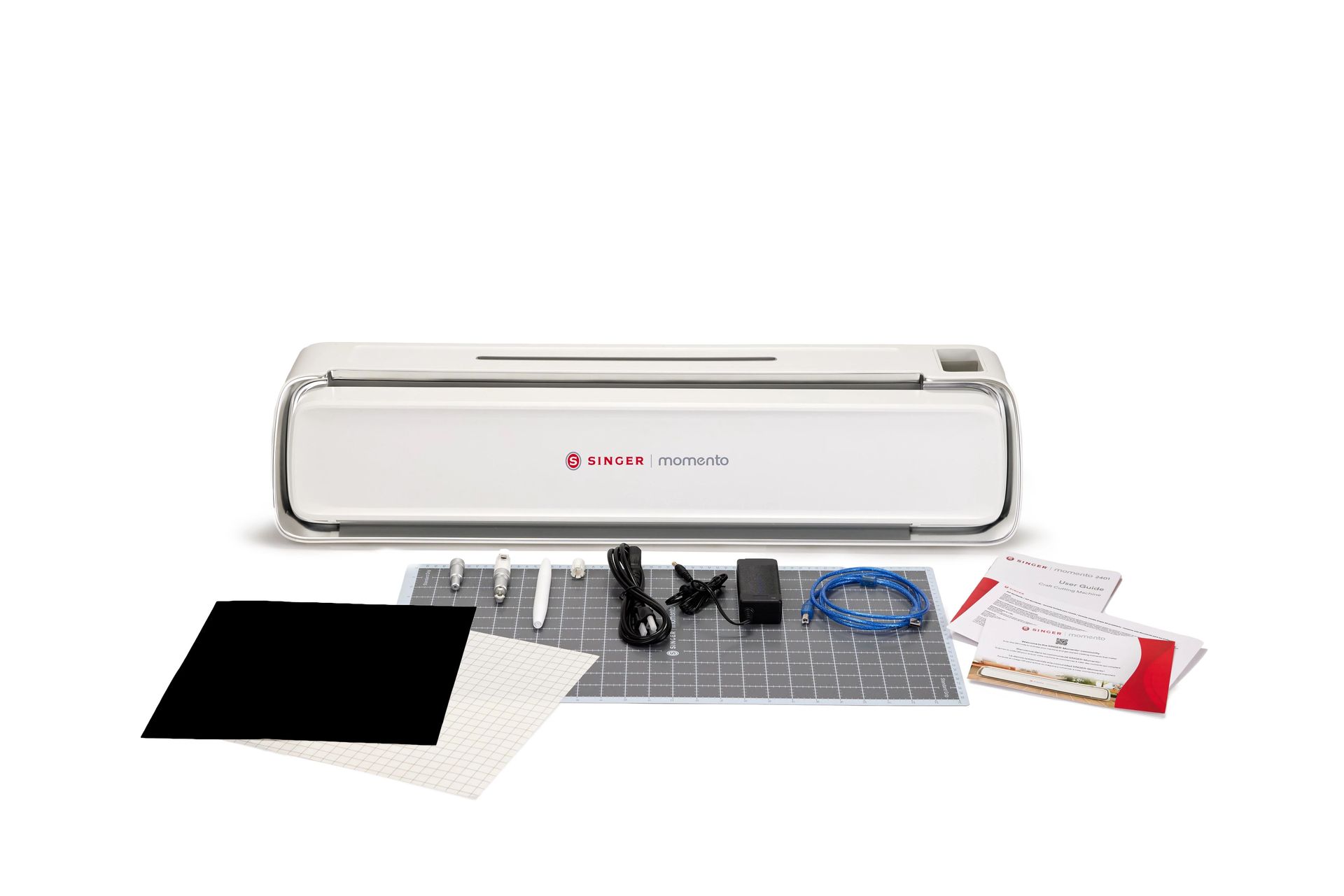 A white cutting machine is sitting on top of a cutting mat.