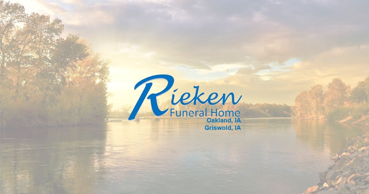Rieken Funeral Home logo on a serene river scene: light blue script over a tranquil, golden-hued landscape.