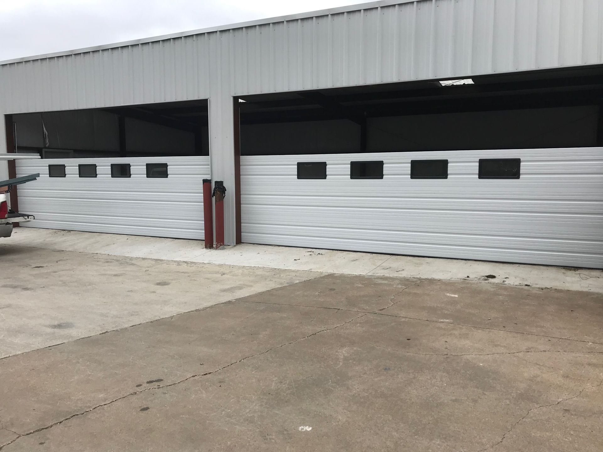An empty garage with a water heater in it.