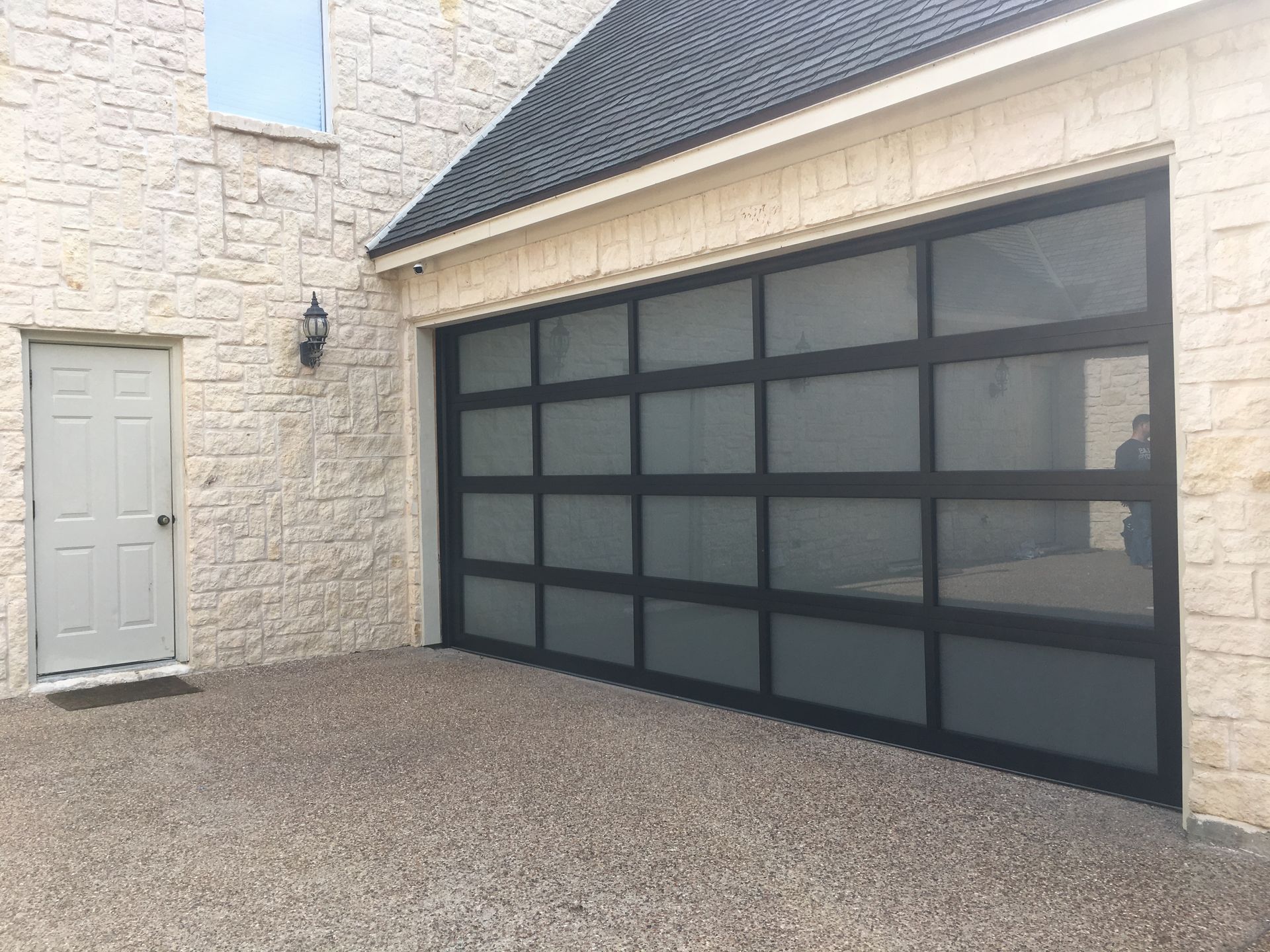 A man is installing a garage door in a garage.