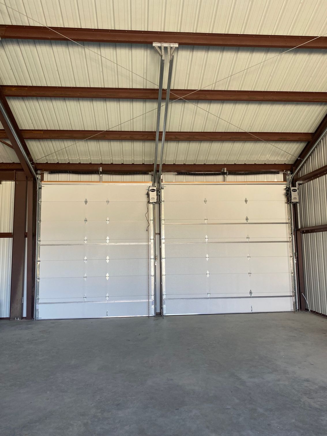 A row of wooden garage doors on a house with columns.