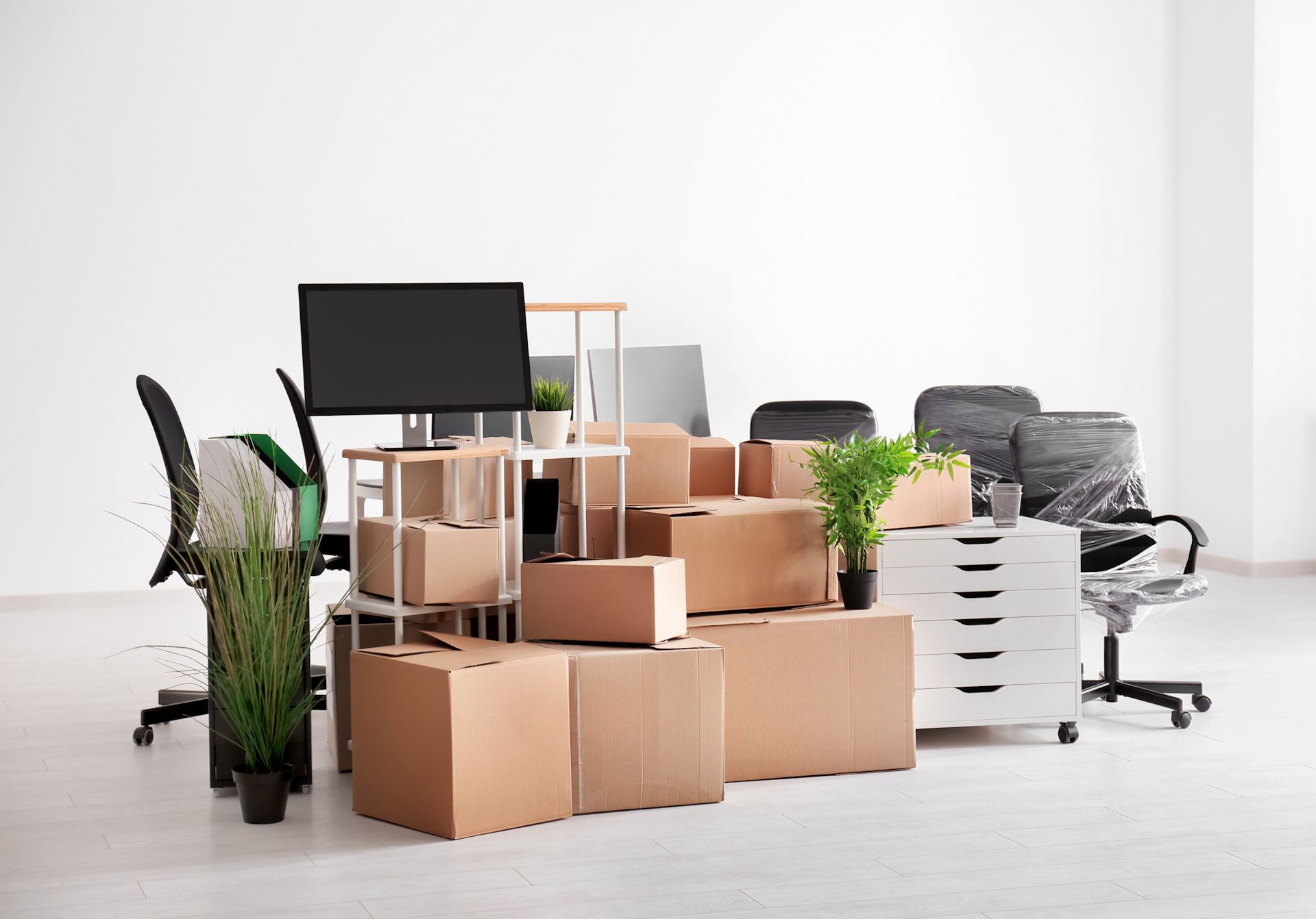 A bunch of cardboard boxes are stacked on top of each other in an office.