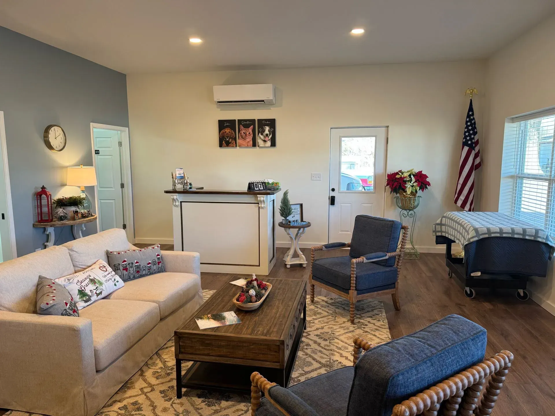 A living room with a couch , chairs , coffee table and american flag.