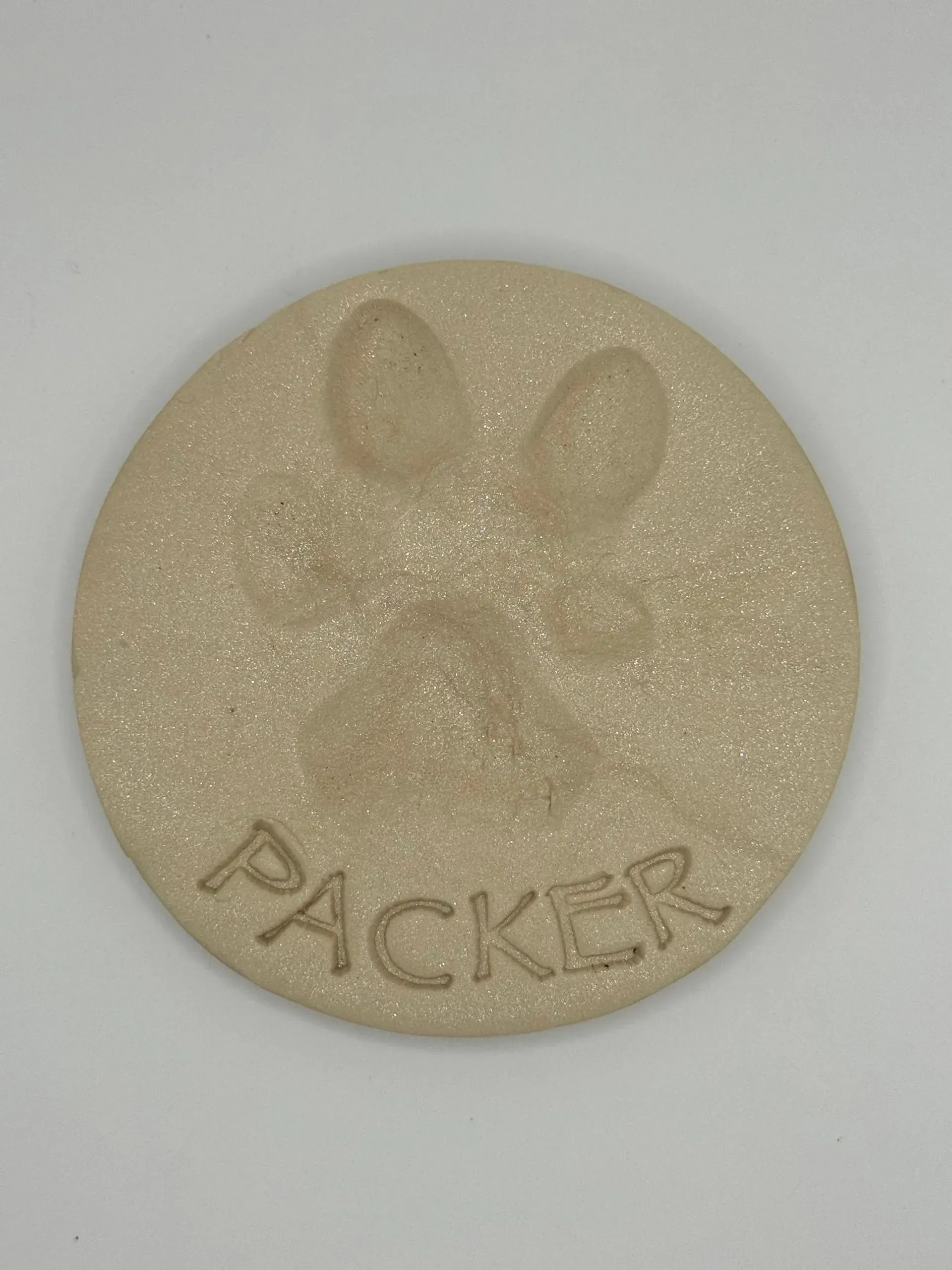A white circle with the word packer written on it