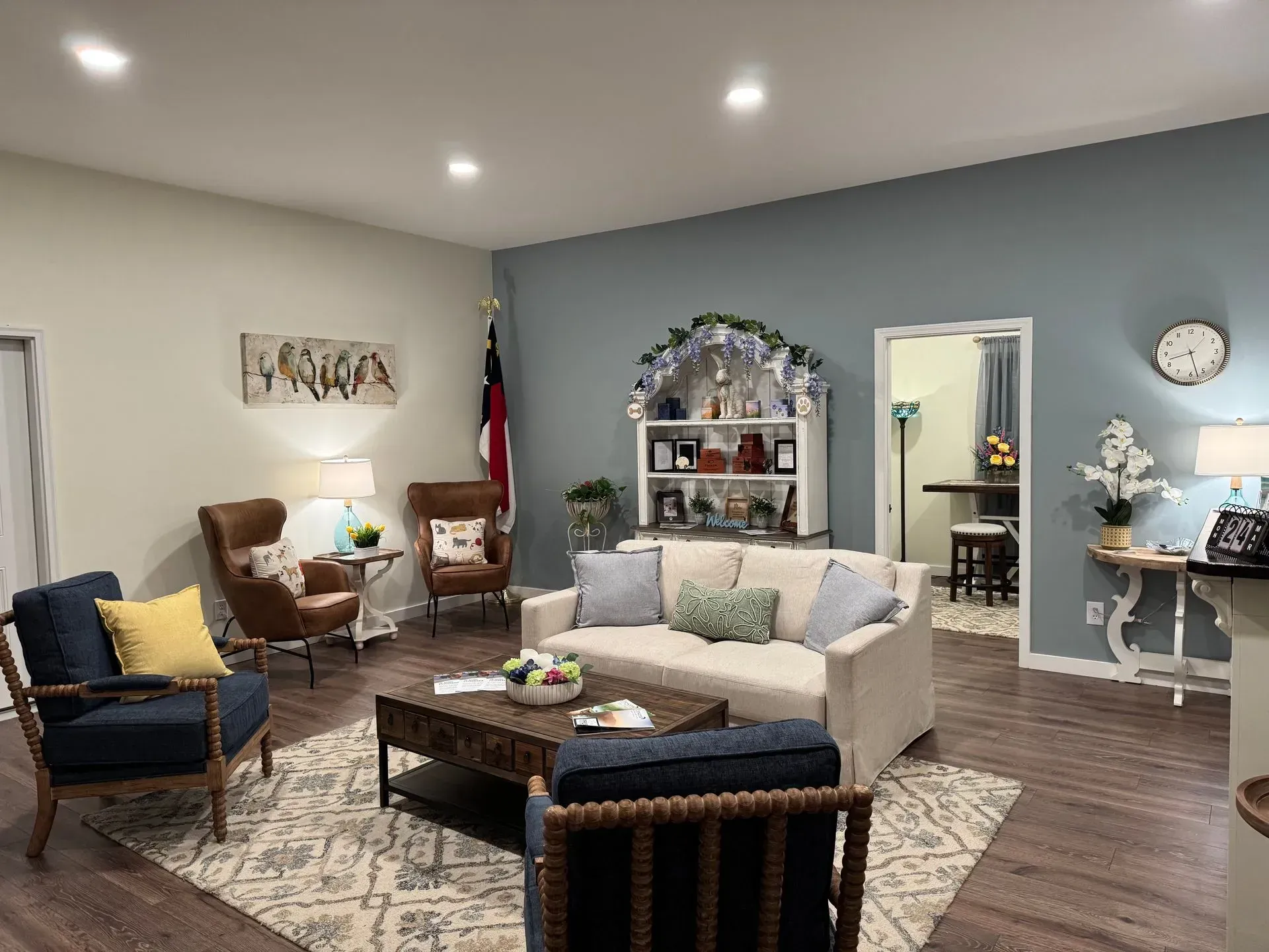 A living room with a couch , chairs , and a coffee table.