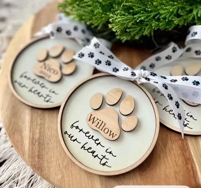 Three wooden circles with paw prints and the words willow forever in our hearts