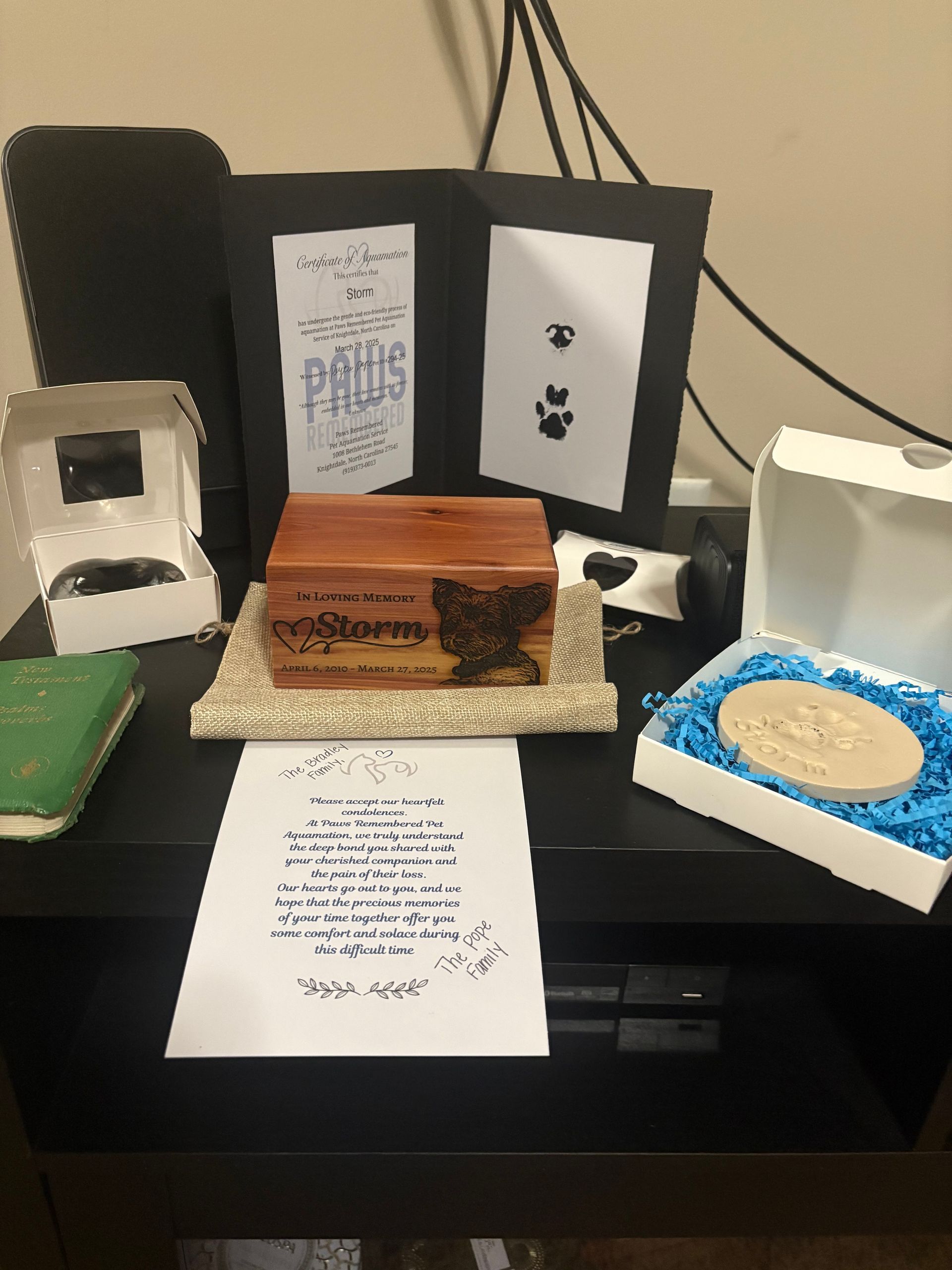 A wooden box with a picture of a cat on it is sitting on top of a table.