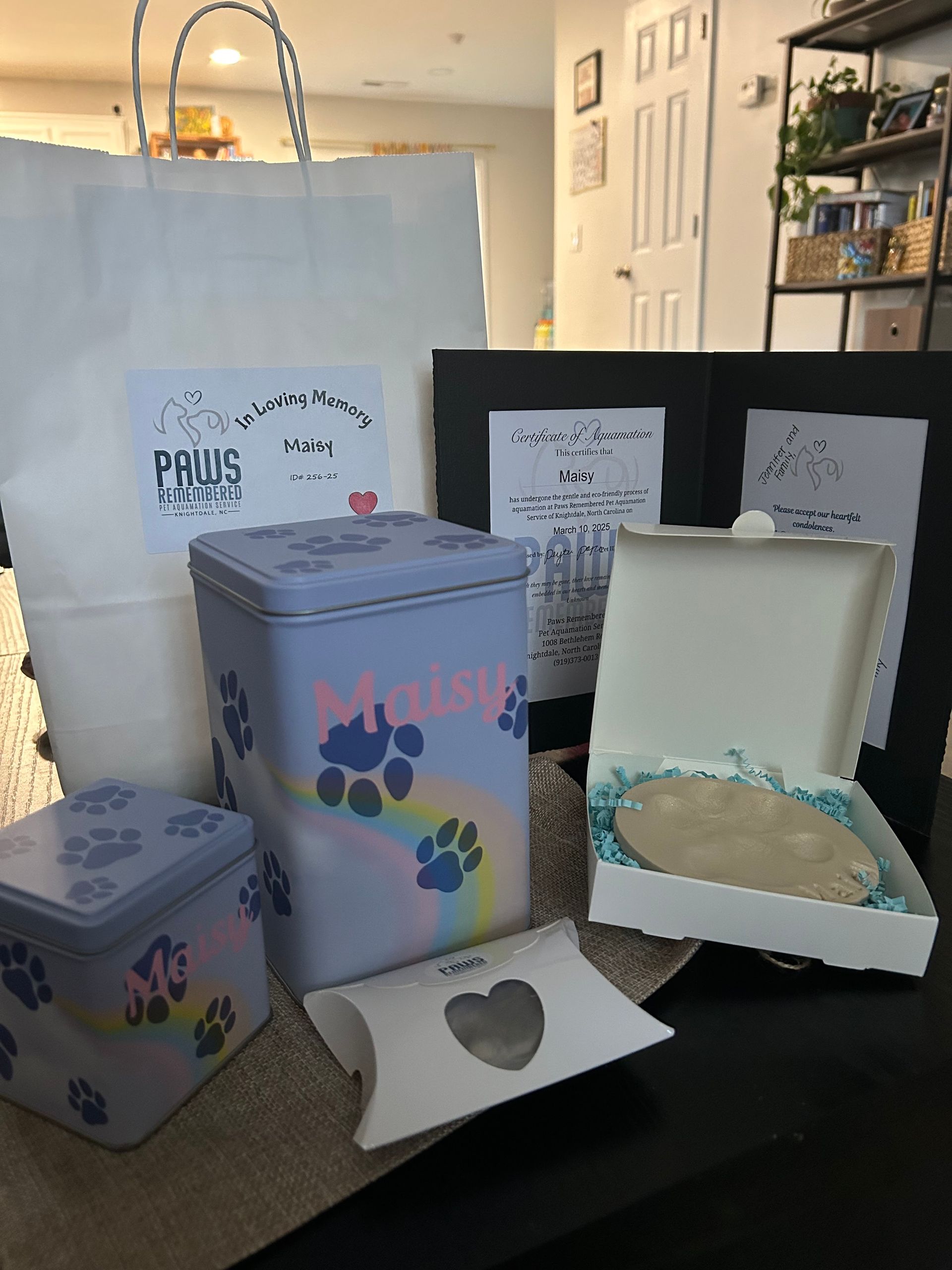 A bunch of boxes with paw prints on them are sitting on a table.