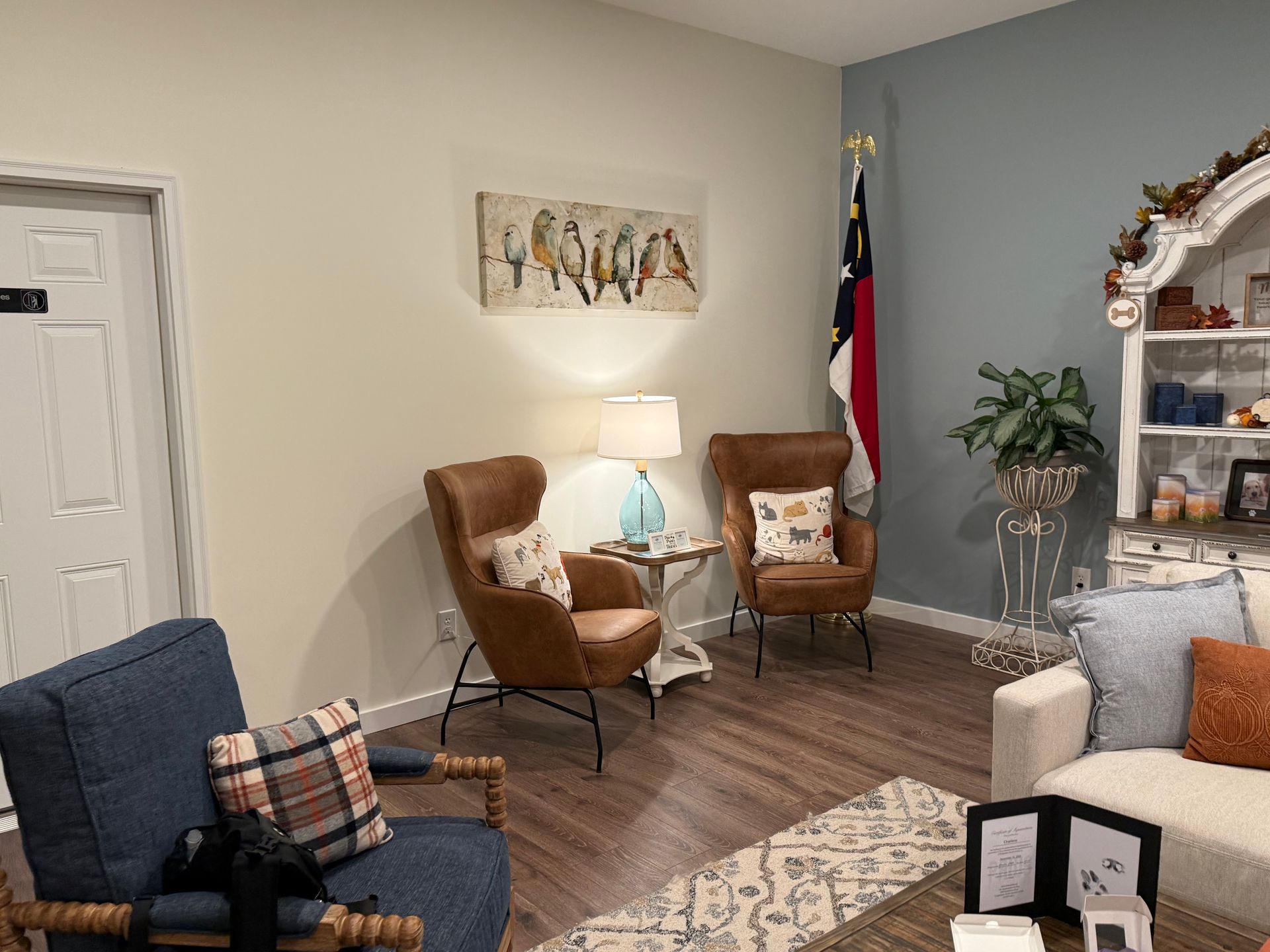 A living room with a couch , chairs , and a flag.