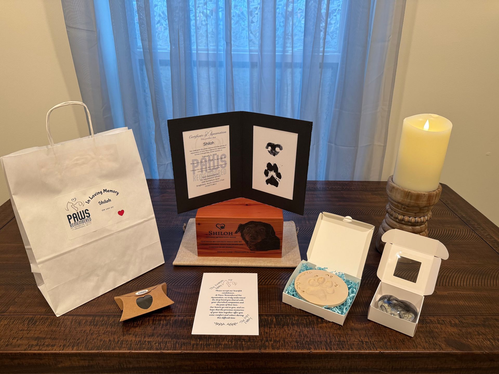 A table with a candle and a bag on it.